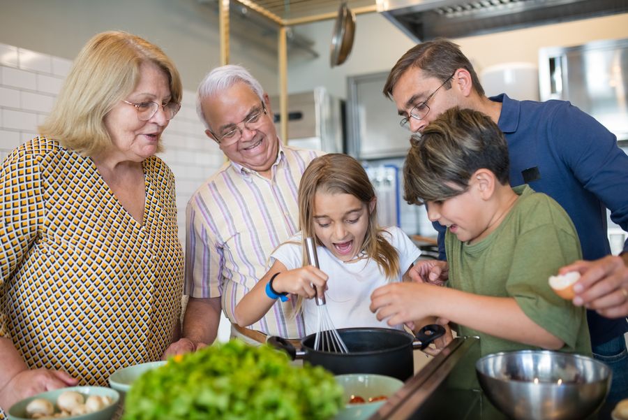 A family cooking together in a warm kitchen